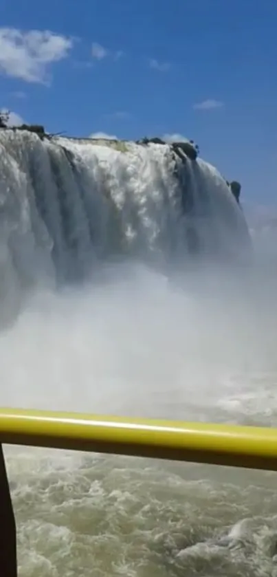 Majestic waterfall with clear blue sky in a serene natural setting.