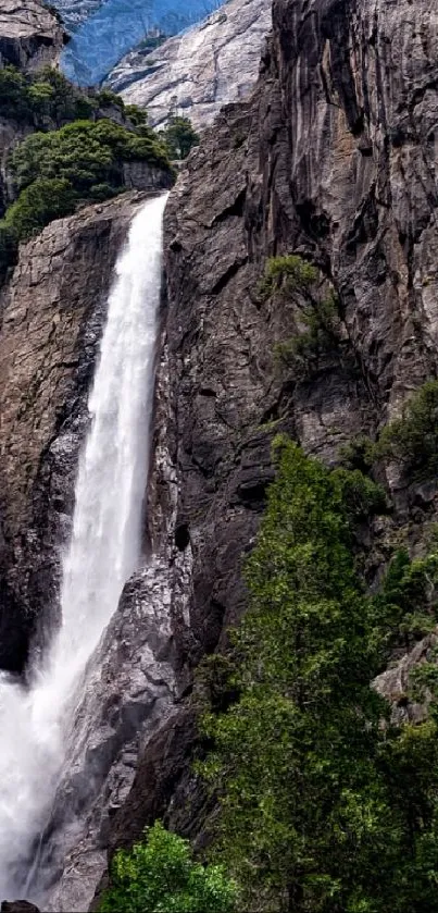 Majestic waterfall cascading down rocky cliffs surrounded by greenery.