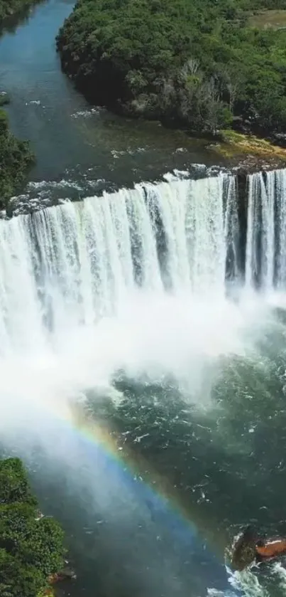 Majestic waterfall cascading into a river with a rainbow.