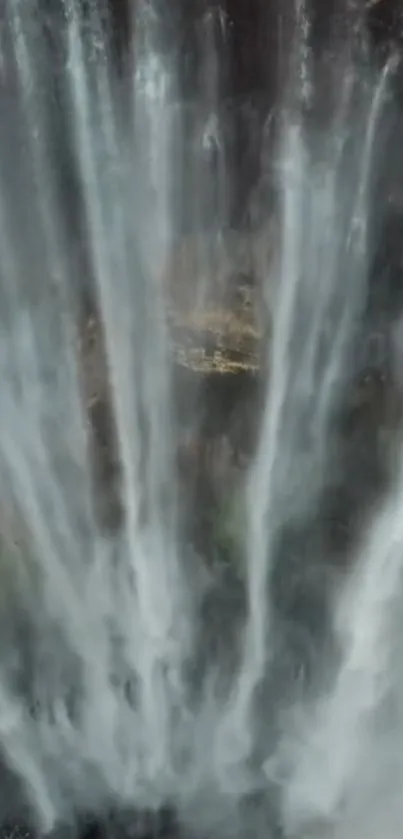 A stunning blue-gray waterfall cascading down a cliff, perfect as a mobile wallpaper.