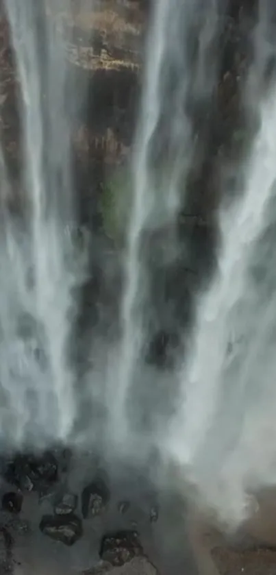 Majestic waterfall cascading down a rocky cliff, creating a serene and tranquil scene.