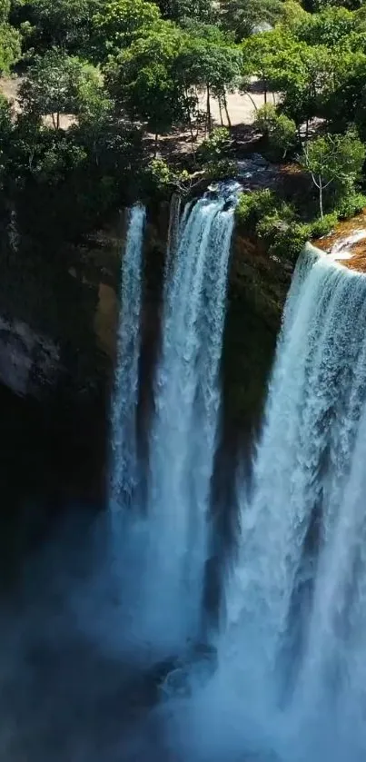 A breathtaking waterfall amidst lush green forest, perfect for mobile wallpaper.