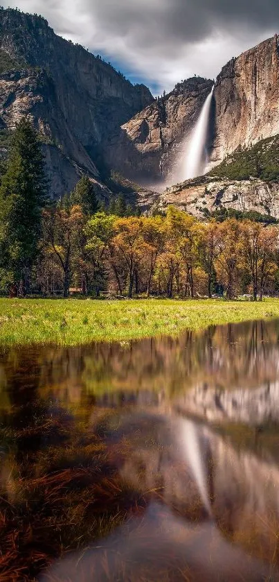 Majestic waterfall amid lush mountains and green landscape.