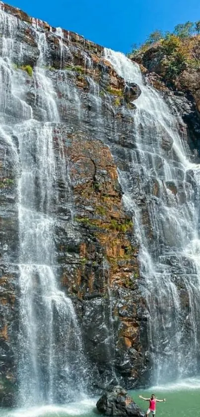 Cascading waterfall with blue sky background.