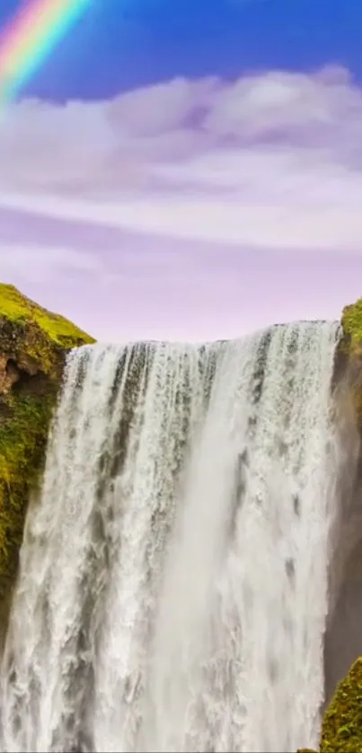 Majestic waterfall with a rainbow over lush green cliffs, perfect for mobile wallpaper.