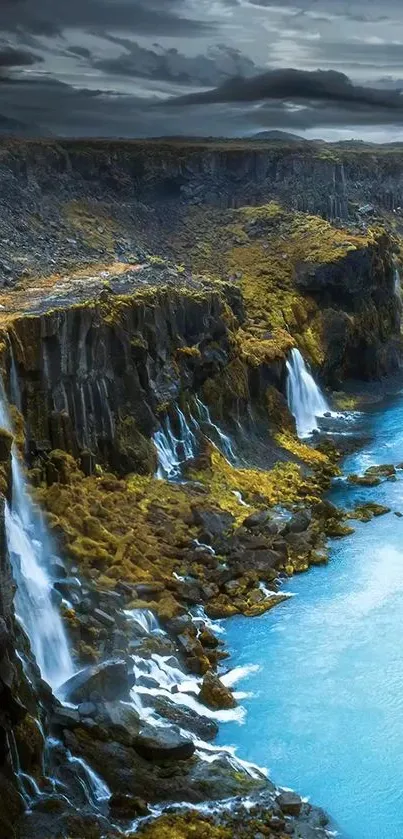 Scenic landscape of waterfalls flowing down rocky cliffs into a blue river.