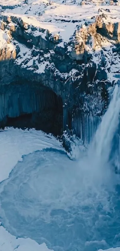 Frozen waterfall in snow-covered landscape.