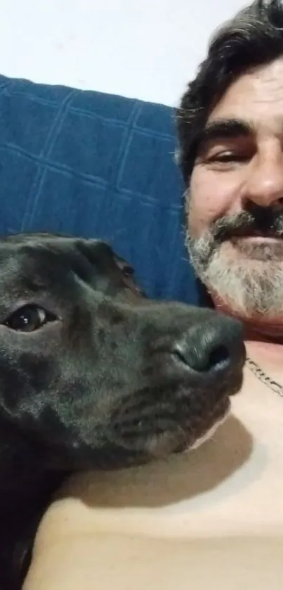 Man with his dog relaxing on a couch.