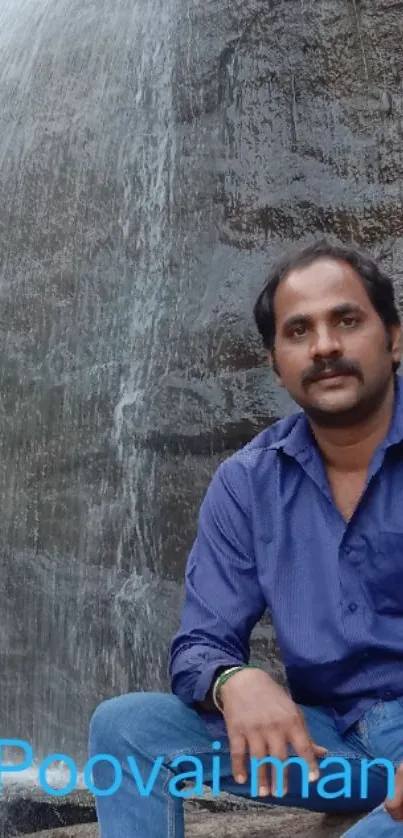 Man sitting by a waterfall in nature.