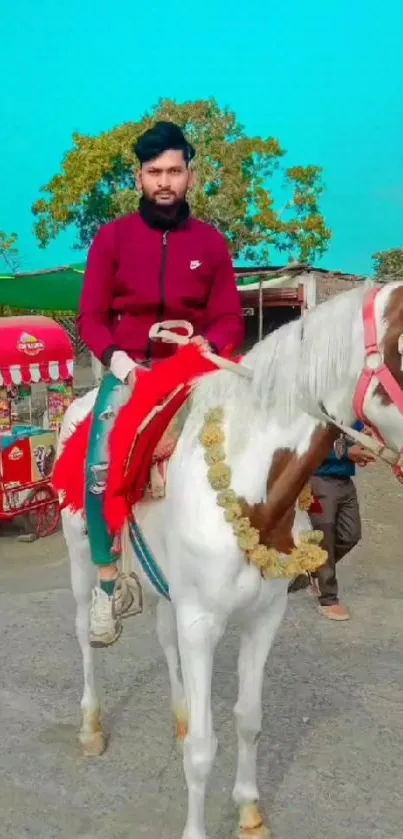 Man riding a decorated white horse outdoors.