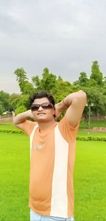 Relaxed man in sunglasses enjoying a sunny park.