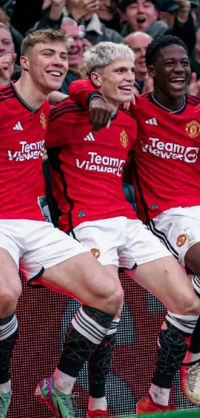 Soccer team celebrating in red jerseys.