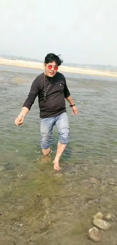 Man walking through a serene river landscape.