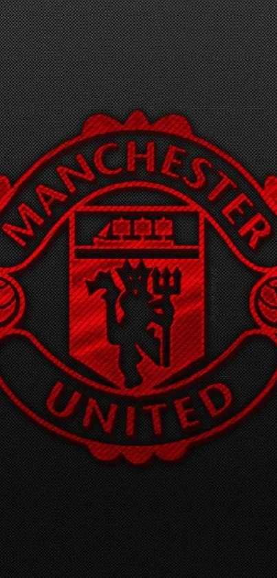 Manchester United logo on a red and black wallpaper.