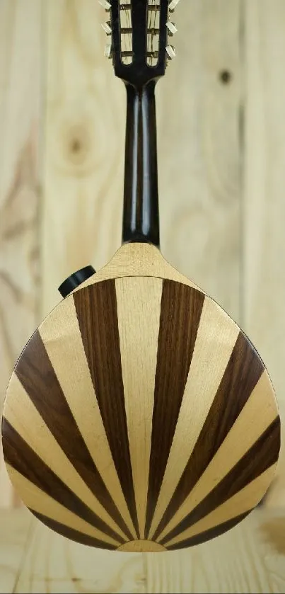 Wooden mandolin with a sunburst pattern on a beige background.