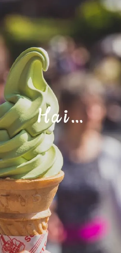 Matcha ice cream cone in hand with blurred street background.