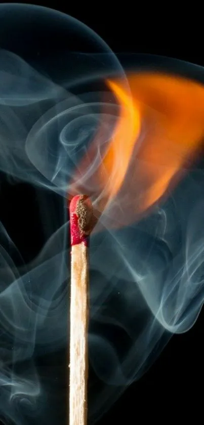 Burning matchstick with swirling smoke on black background wallpaper.