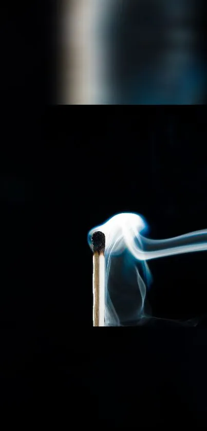 Lit matchstick with dark smoky background.