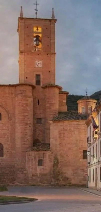 A medieval church building at dusk with historical architecture and stone façade.