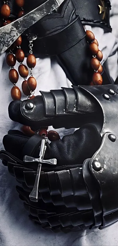 Medieval armored gauntlet clutching a rosary.