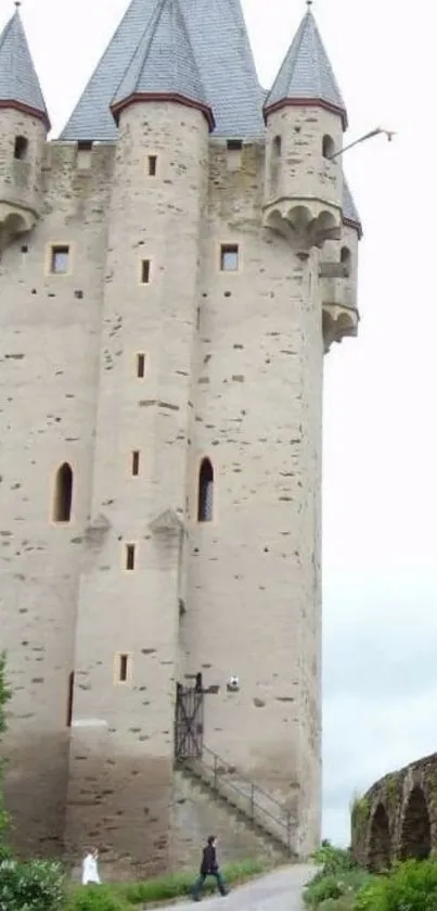 Majestic medieval tower under cloudy sky.