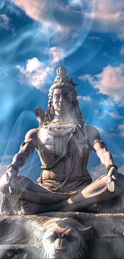 Shiva statue meditating under a blue sky with clouds.