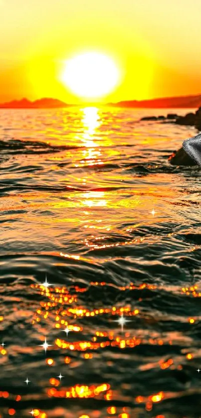 Mermaid on rocks at sunset over ocean with golden reflections.