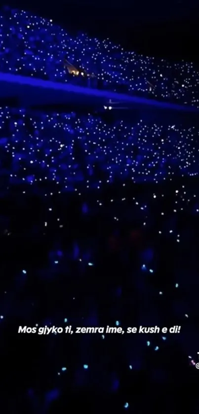 Concert arena filled with vibrant blue lights creating a dazzling effect.