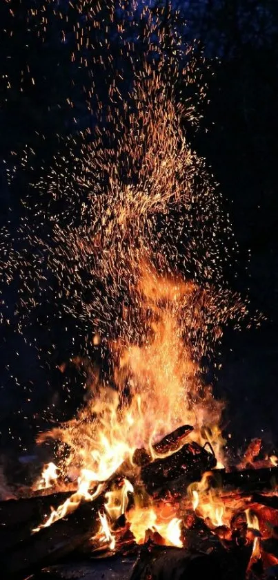 Vibrant campfire with orange flames against a nighttime backdrop.