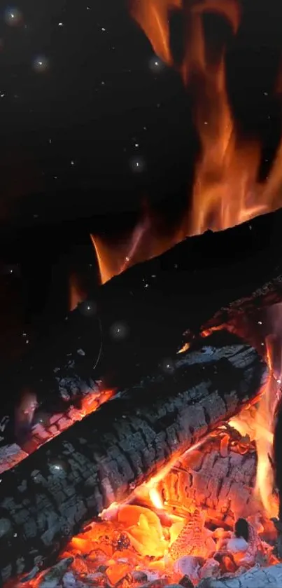 Mesmerizing flames and embers under a starry night sky wallpaper.