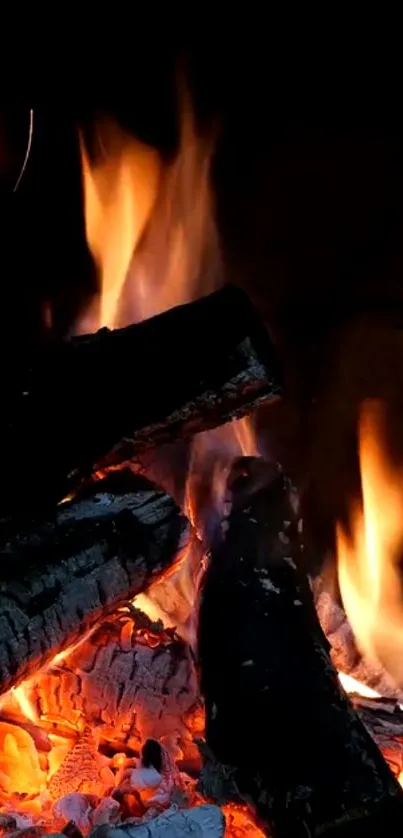 Mobile wallpaper showing vibrant flames and burning wood in orange hues.