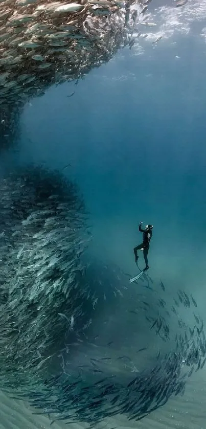 Diver surrounded by swirling fish in deep blue ocean.