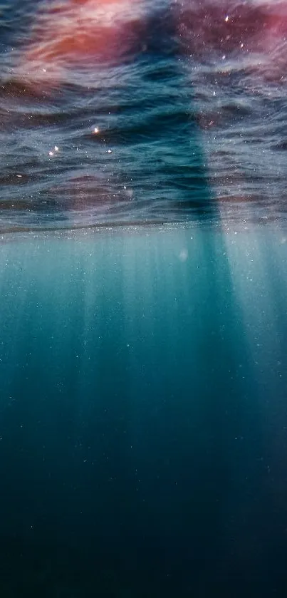 Underwater view with sunlight rays merging in tranquil ocean blue.