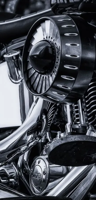 Black and white close-up of a motorcycle engine showcasing metallic details.