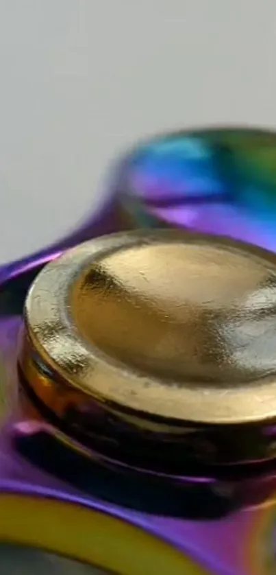 Close-up view of metallic fidget spinner with vibrant colors.