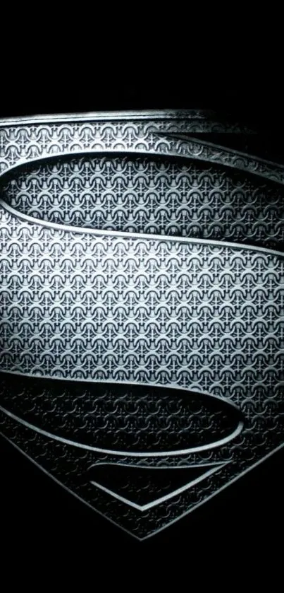 Metallic superhero emblem on a black background wallpaper.