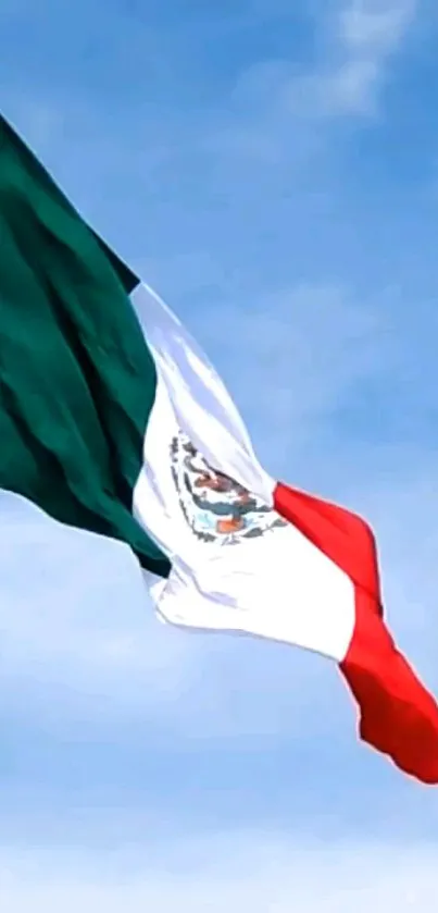 Waving Mexican flag against a clear blue sky.