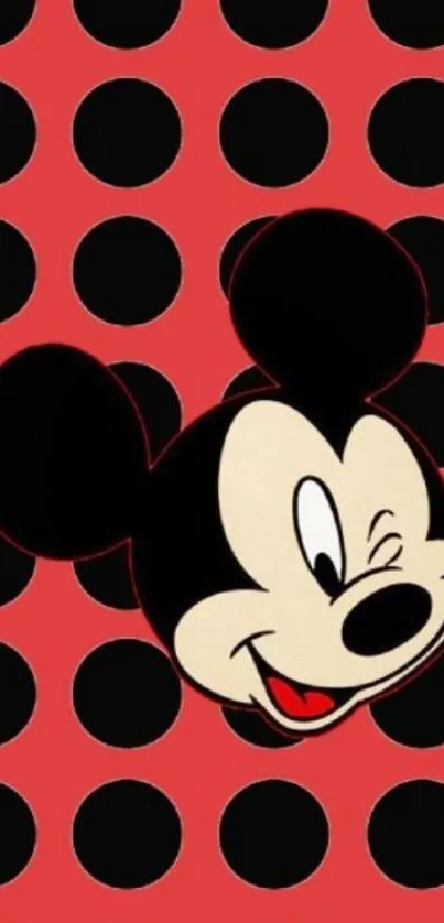 Mickey Mouse on red dotted wallpaper, ideal for mobile screens.