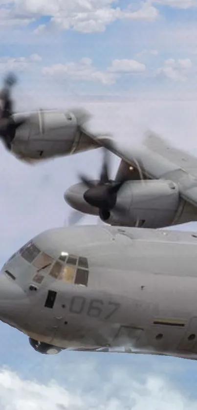 Military airplane flying through cloudy sky.