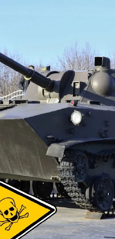 Tank with caution sign on display in a park.