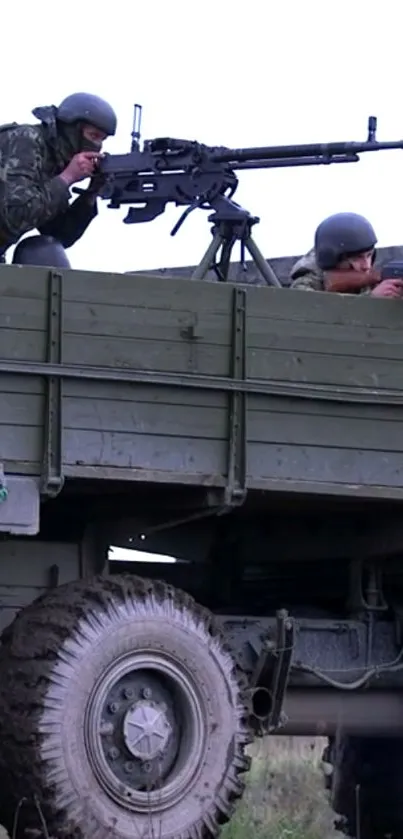 Military truck with soldiers aiming equipment.