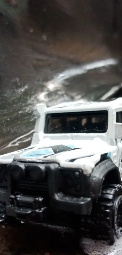 Miniature white truck on a muddy trail.