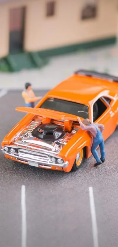 Miniature scene with orange car and tiny figures.