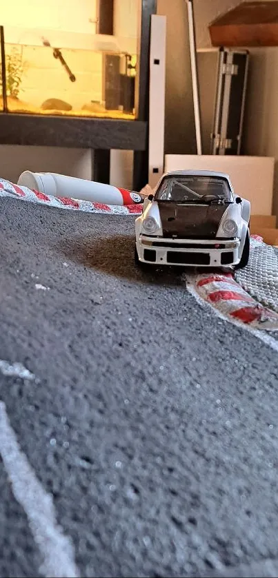 Miniature rally car on winding model track.