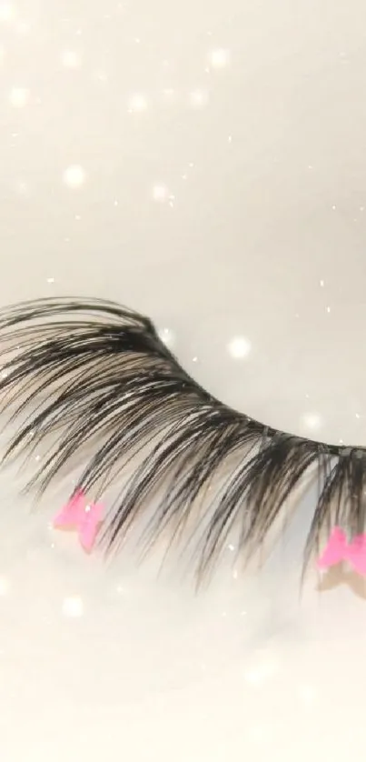 Elegant eyelash with pink accents on beige background.