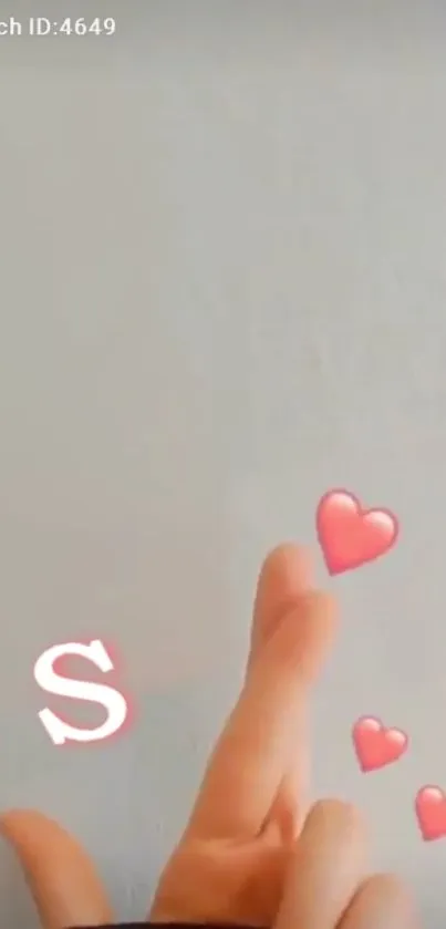 Hand gesture with floating hearts on light gray background.