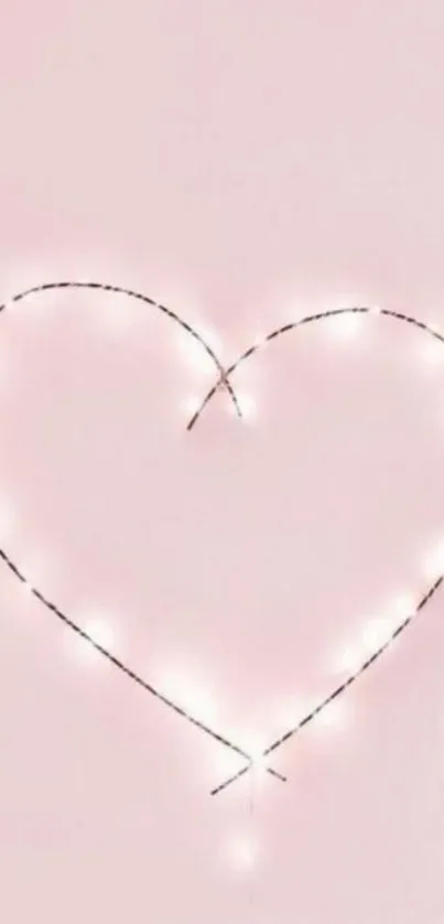 Minimalist heart with string lights on a pale pink background.