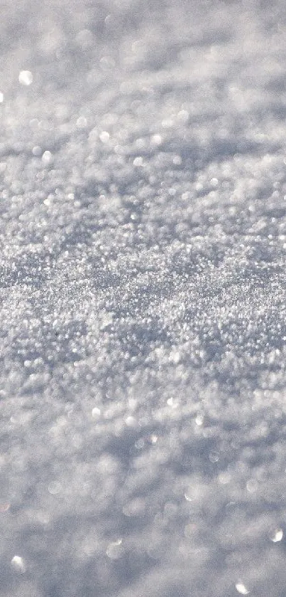 Close-up of shimmering white snow texture, perfect for a calm phone wallpaper.