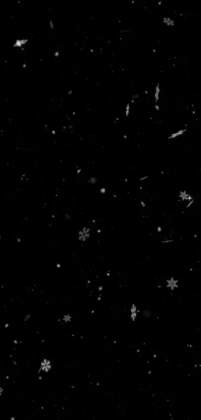 Minimalist wallpaper with snowflakes on black background.