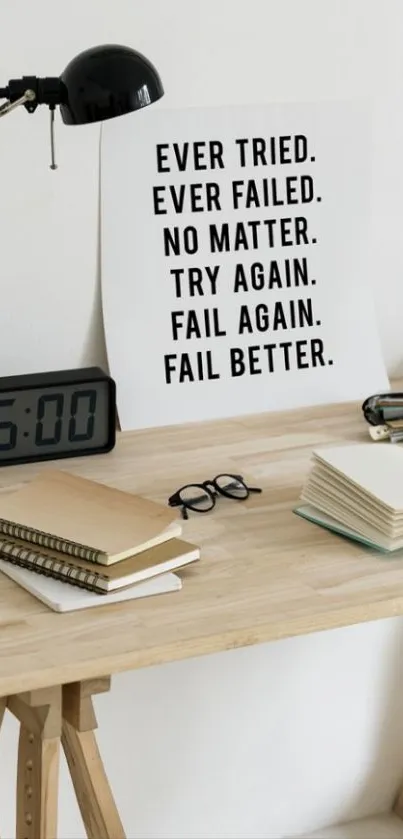 Minimalist desk with motivational quote poster and books.
